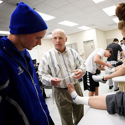 a faculty member and student treat a patient at a clinic